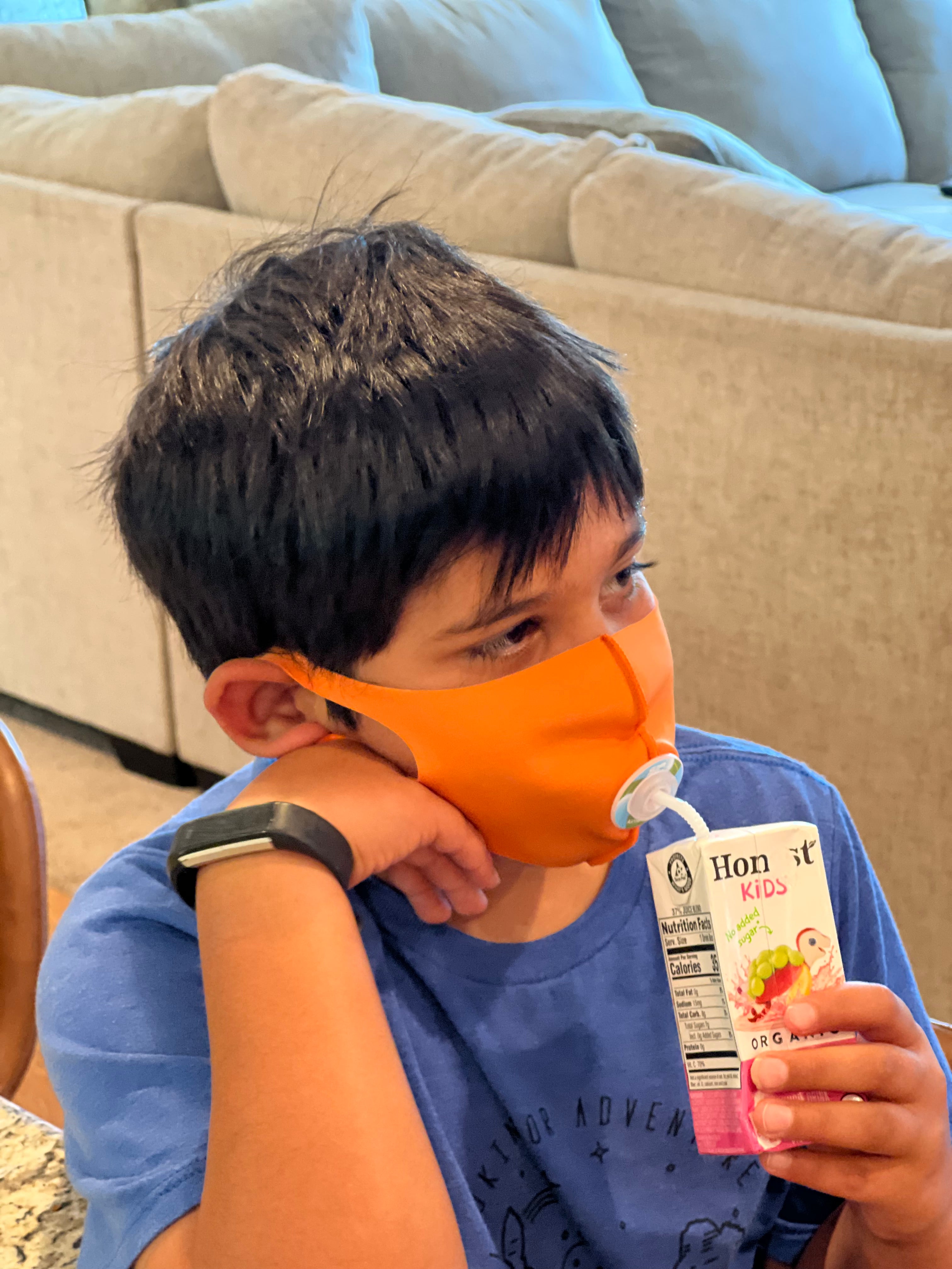 child using SIP valve and straw to drink through face mask