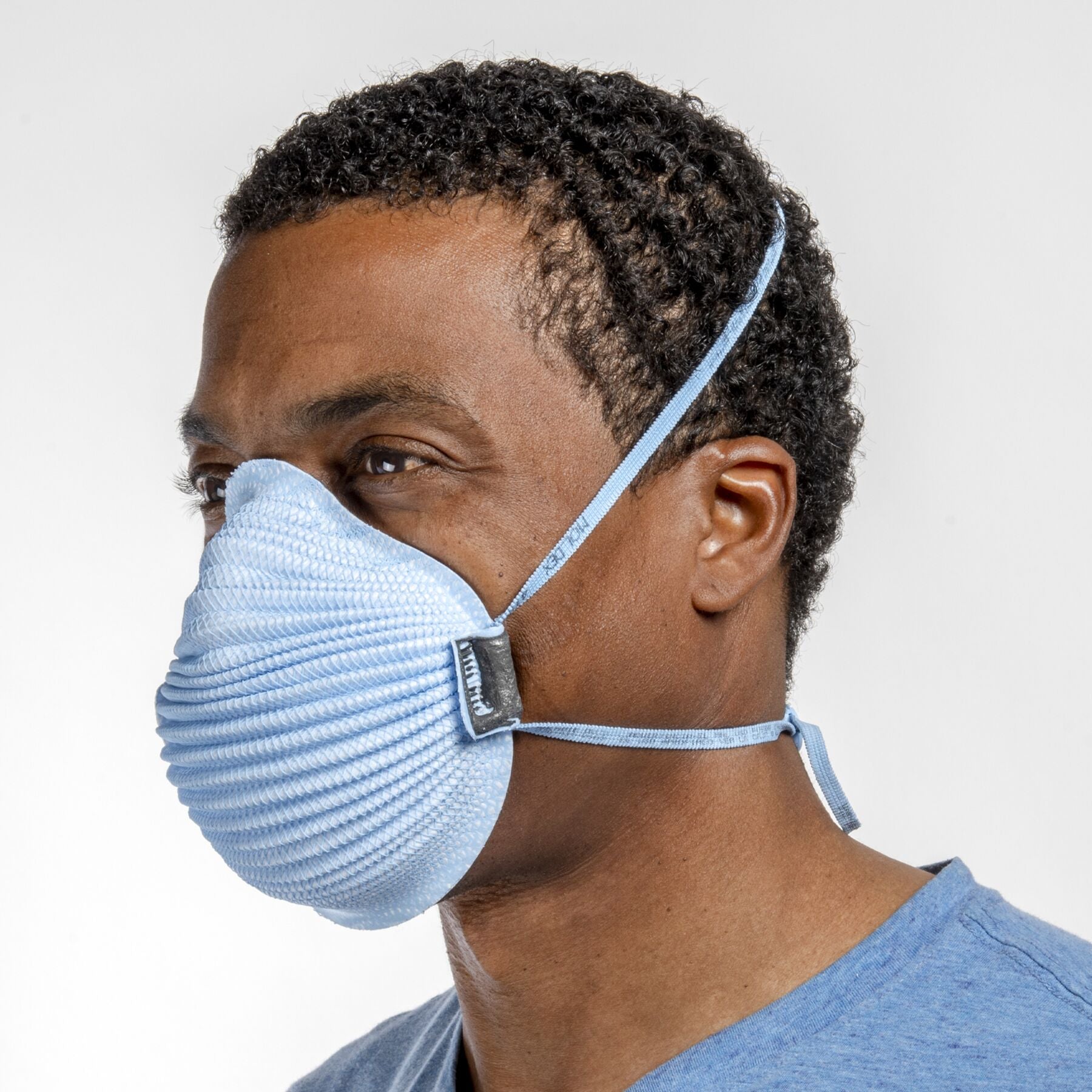 Man healthcare worker wearing blue Airwave 4150 NIOSH N95 surgical respirator from Canada Strong Masks.